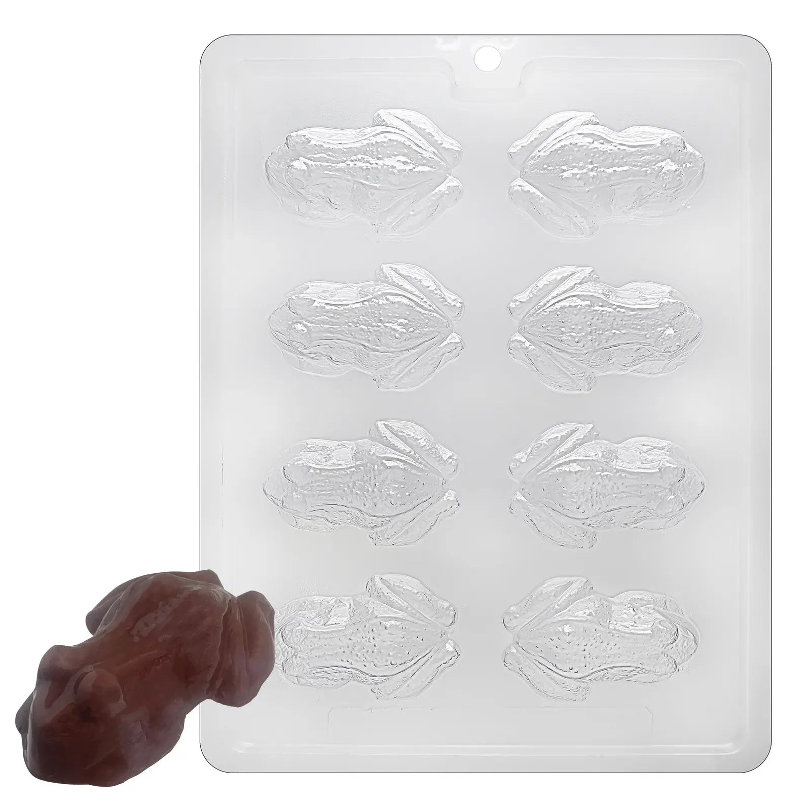 A rectangular translucent silicone mold with six frog-shaped cavities, shown on a white background with a small brown frog-shaped sample in front.