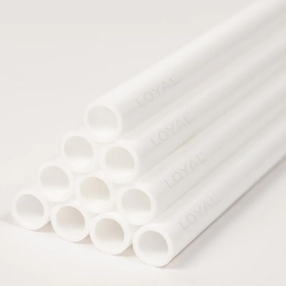 White hollow cake dowels on a white background